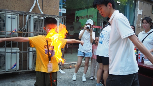 团队成员引导小朋友体验化学实验。重庆师范大学供图